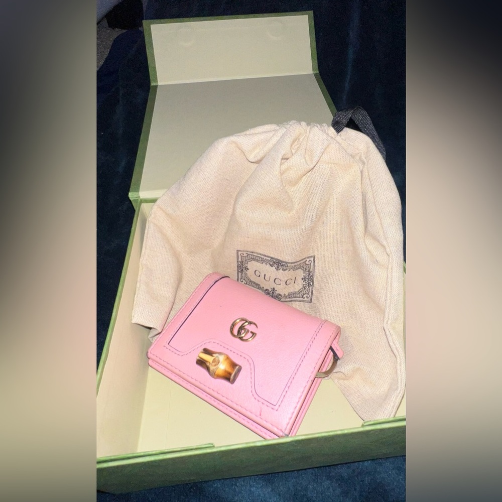 Pink gucci wallet with box and bag.